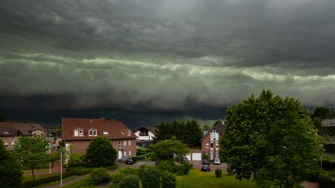 Timelapse zooming in of a spectacular cloud front of a thunderstorm turning day into night. The thunderstorm was one of the worst of the last decade in the west of Germany and caused heavy damage.