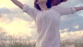 Happy girl with long hair having fun outdoor. Beauty girl spinning, laughing and catching soap bubbles. Countryside. Nature. Freedom. Slow motion video footage 1080p full HD. High speed camera shot