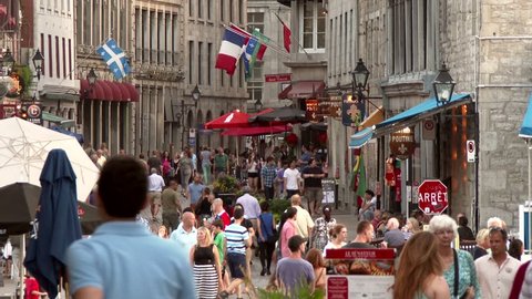 Montreal, Canada - June 2014 - 4K UHD - Busy old european town with tourist shops, restaurants and flags