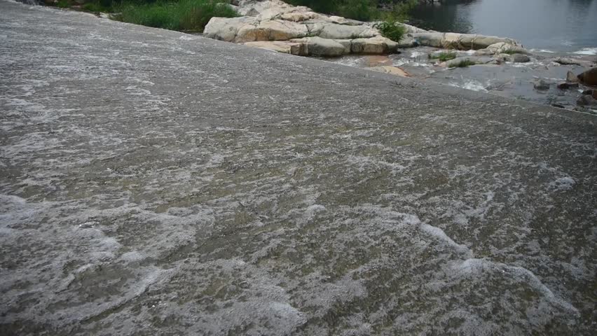 Torrential waterfall & spindrift running to dam. 