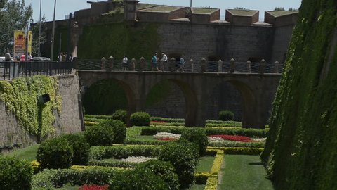 BARCELONA, SPAIN - 1 JULY 2014 -  Tourist crossing bridge into Montjuic fortress.