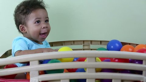Baby playing with colorful balls