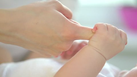 Parent holding newborns hand. Hand in hand. Mother and her Newborn Baby. Happy Mother and Baby together. Maternity concept. Parenthood. Motherhood. Family.1080p full hd Video Footage. Slow Motion