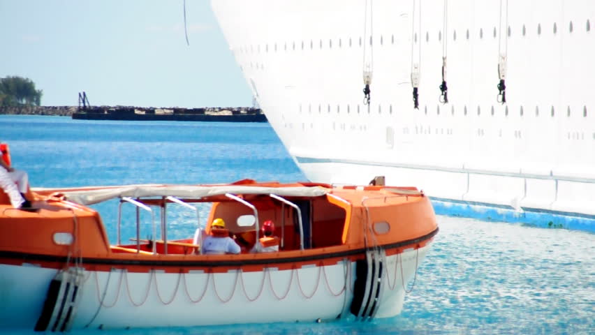 Lifeboats from a cruise ship test their engines in a harbor near Nassau in the