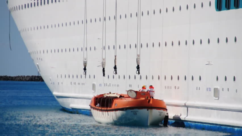 Lifeboats from a cruise ship test their engines in a harbor near Nassau in the