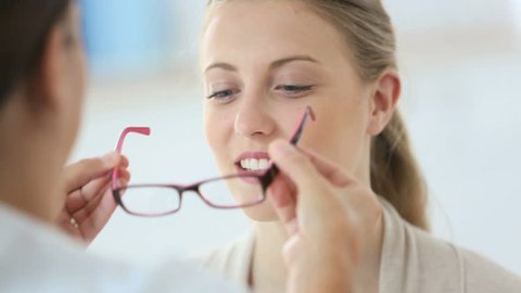 Woman trying new eyeglasses with ophtalmologist