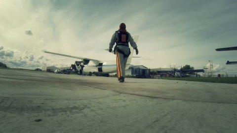 Aerodrome. A woman goes to the plane that would bail out.