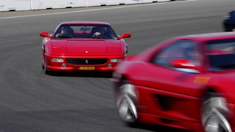 ZANDVOORT, THE NETHERLANDS - JUNE 29: Various Ferrari sports cars on track during the Italia a Zandvoort event at the race track. The cars are two F355, 599 GTB, 360 Modena Spider and 458 Italia 
