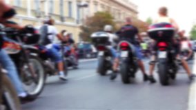 Large group of bike riders passing through town in the parade, blurred video clip/Motorcycle riders