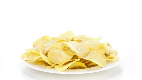Potato chips rotating on the white table with white seamless background