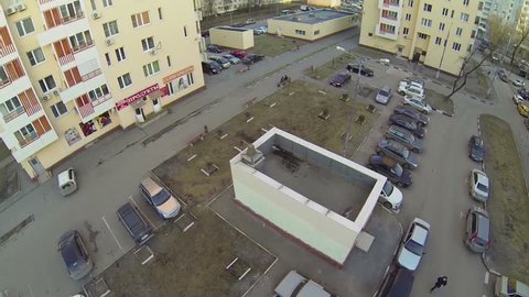 Car parking on yard near dwelling houses at spring day. Aerial view