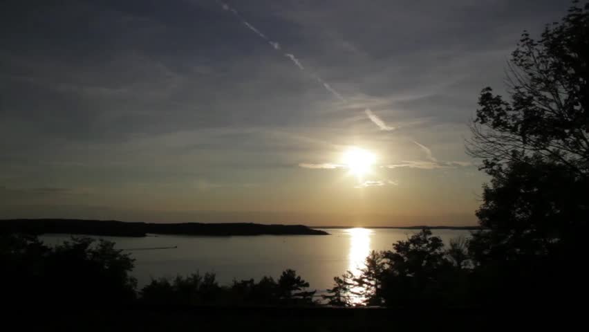 Panoramic view of evening sky in Parry Sound, with lone boat passing by.