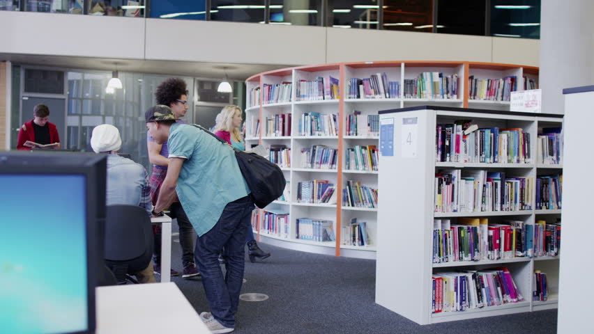 Diverse student group studying together in modern college library