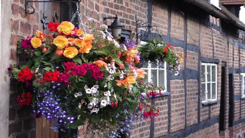 Hanging flowers outside a house in the old English historic village of Great Budworth, Cheshire.