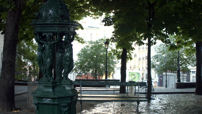 PARIS FRANCE- JULY 2, 2014: A fountain Wallace in Place Émile Goudeau in Paris. Wallace fountains are public drinking fountains designed by Charles-Auguste Lebourg