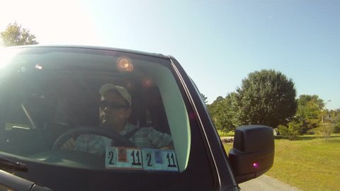A man drives on a sunny summer day.