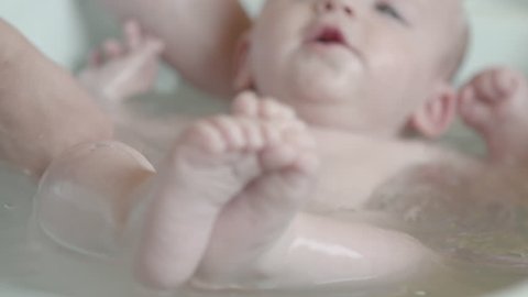 4 months old baby bath time  only little feet in focus