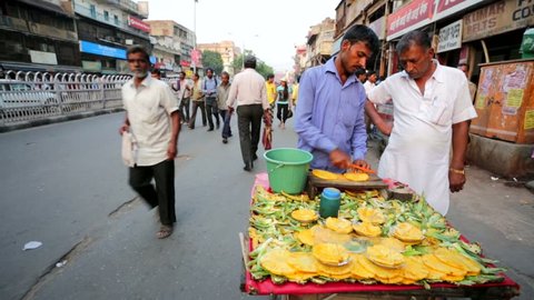 DELHI, INDIA - CIRCA MAY 2014: Street vendor sells ready to eat pineapples.