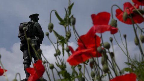 IRONBRIDGE GORGE, TELFORD, SHROPSHIRE- JULY 2014: Soldiers World War Memorial Statue with red poppies