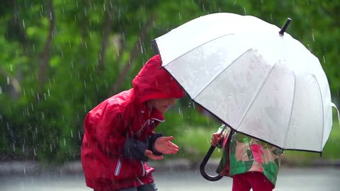Boy running up to girl and sheltering under her umbrella