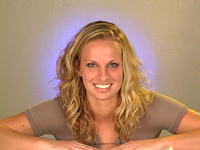 Close-up of a lovely young blonde with a bright, warm smile. 