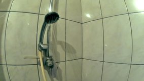 Water sprays out of shower head - Stock Video. Water over camera