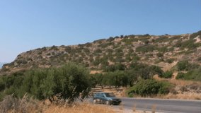 Highway on Crete with cars passing. This clip was filmed near the ruins of Gournia