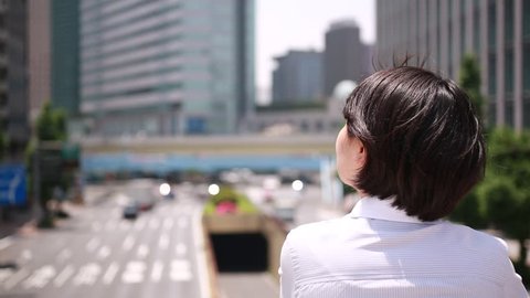 Japanese young businesswoman looking away, Tokyo, Japan Stock Video