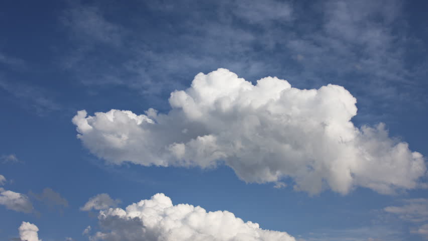 A Cumulus cloud churns and transforms against a deep blue sky. HD 1080p Time