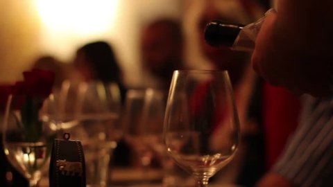 Waitress pouring red wine into glass วิดีโอสต็อก