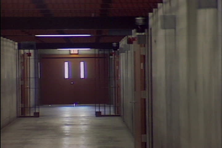 A series of closing gates in a prison.