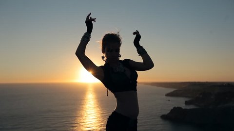  Amazing girl dancing belly dance at sunset near the sea
