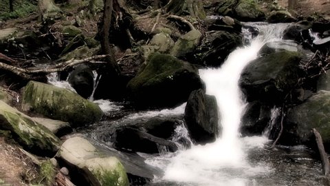 Misty spring waterfall at Bushkill falls Pennsylvania.  The water is in slow motion 