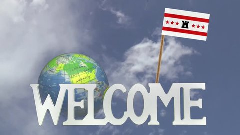 The word WELCOME in front of a turning globe and moving clouds in a blue sky with tooth pick and a small paper flag of DRENTHE