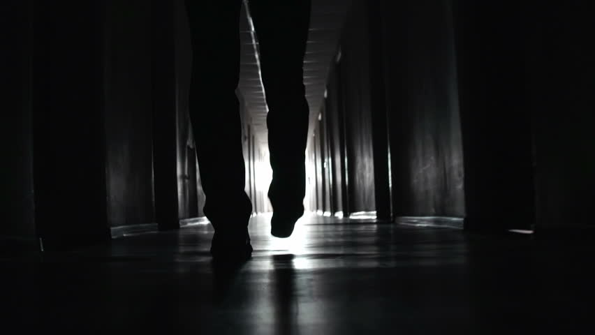 Shaky camera following footsteps of unrecognizable man going along the walkway in the dark Royalty-Free Stock Footage #6854404