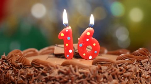 Candles on a cake are blown out for a 16th birthday - sixteen years old