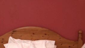 Delightful woman on phone lying down on bed at home 