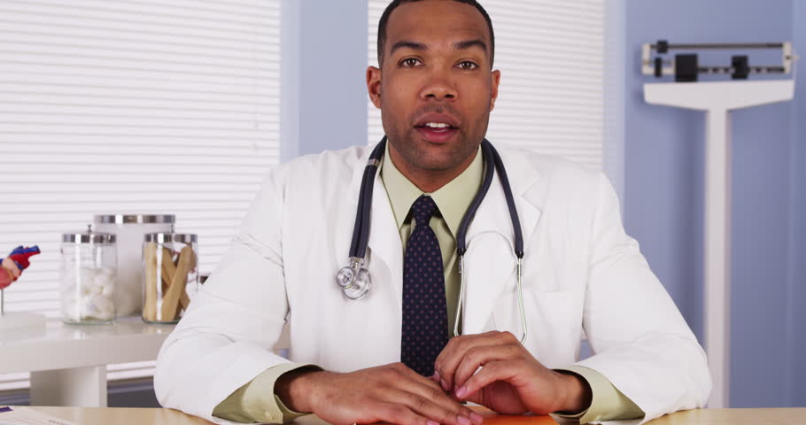 Black doctor talking to camera Royalty-Free Stock Footage #6859792