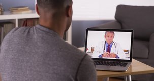African patient talking to doctor on laptop