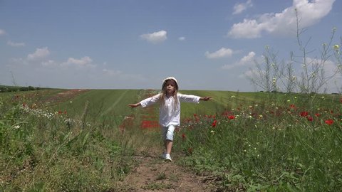 View Happy Little Girl Walking in Farmland, Small Countrywoman Child in Poppy Flower Field, Children in Countryside, POV
