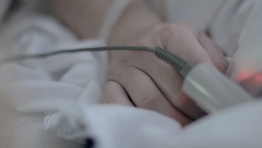 A little girl holds and kisses a hospital patient’s hand which has a monitor attached | Shutterstock HD Video #6867760