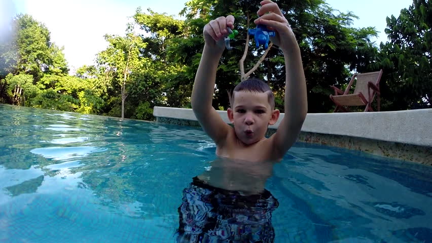 Boy swimming underwater in pool