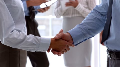 Business team shaking hands close up in slow motion