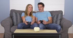 Couple in matching clothes playing video games
