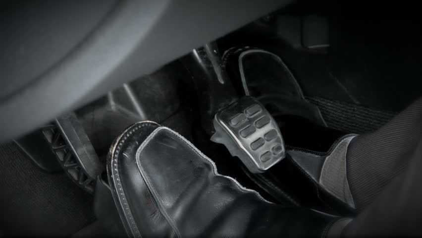 This is a shot of a sports car's pedals.  The driver changes feet quickly as