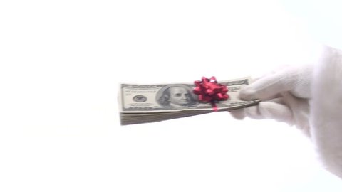 Generous Santa gives stack of cash topped with festive bow isolated on white