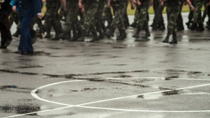 Soldiers marching in the rain. RAW video record.
