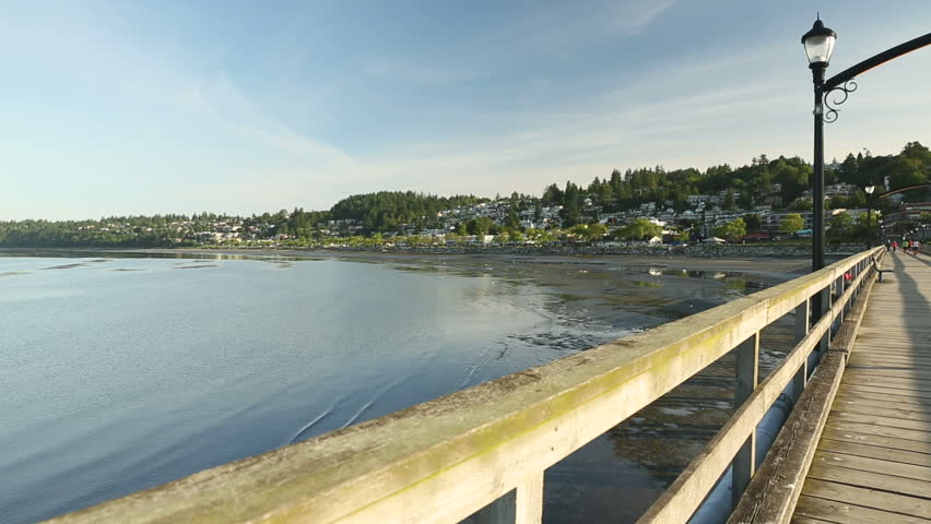 White Rock Pier and Shoreline dolly shot. Low tide in White Rock, a popular tourist destination on the west coast of British Columbia near the United States border. Canada.
