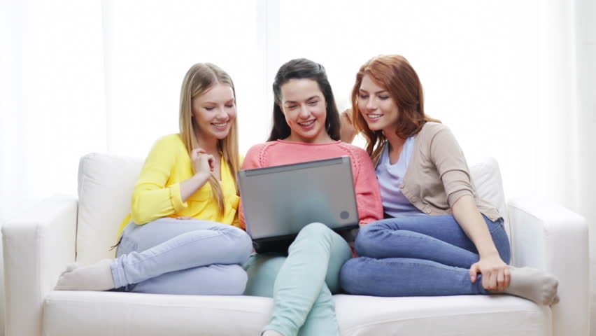 Friendship, technology and internet concept - three smiling teenage girls with laptop computer at home | Shutterstock HD Video #6899263