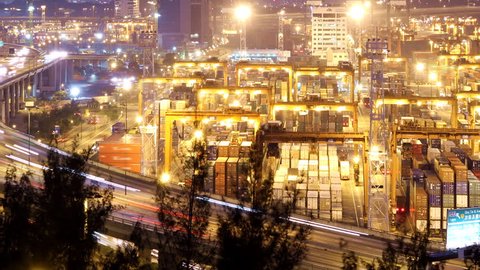 Busy City Night Timelapse. Pan shot from cargo container terminal at the right to busy traffic highway at the left.